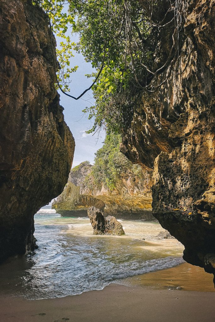 A beautiful scenic beach with a cave of Saluban Beach in Uluwatu, Bali