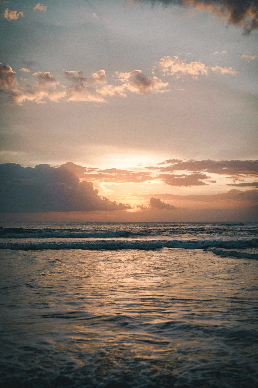 Thomas Beach in Uluwatu, Bali, featuring a peaceful shoreline, turquoise water, and soft golden sand.